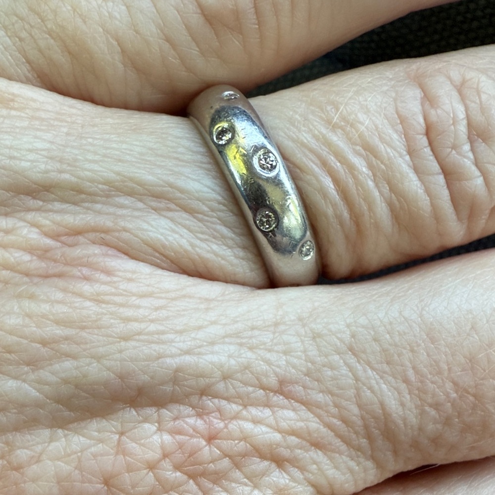 Platinum and Diamond band size 7, approx 1/2”. Dry wrinkly hand not included.